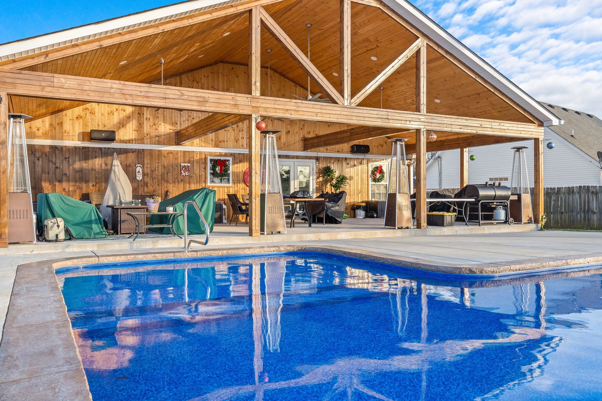 A large house with a swimming pool in front of it