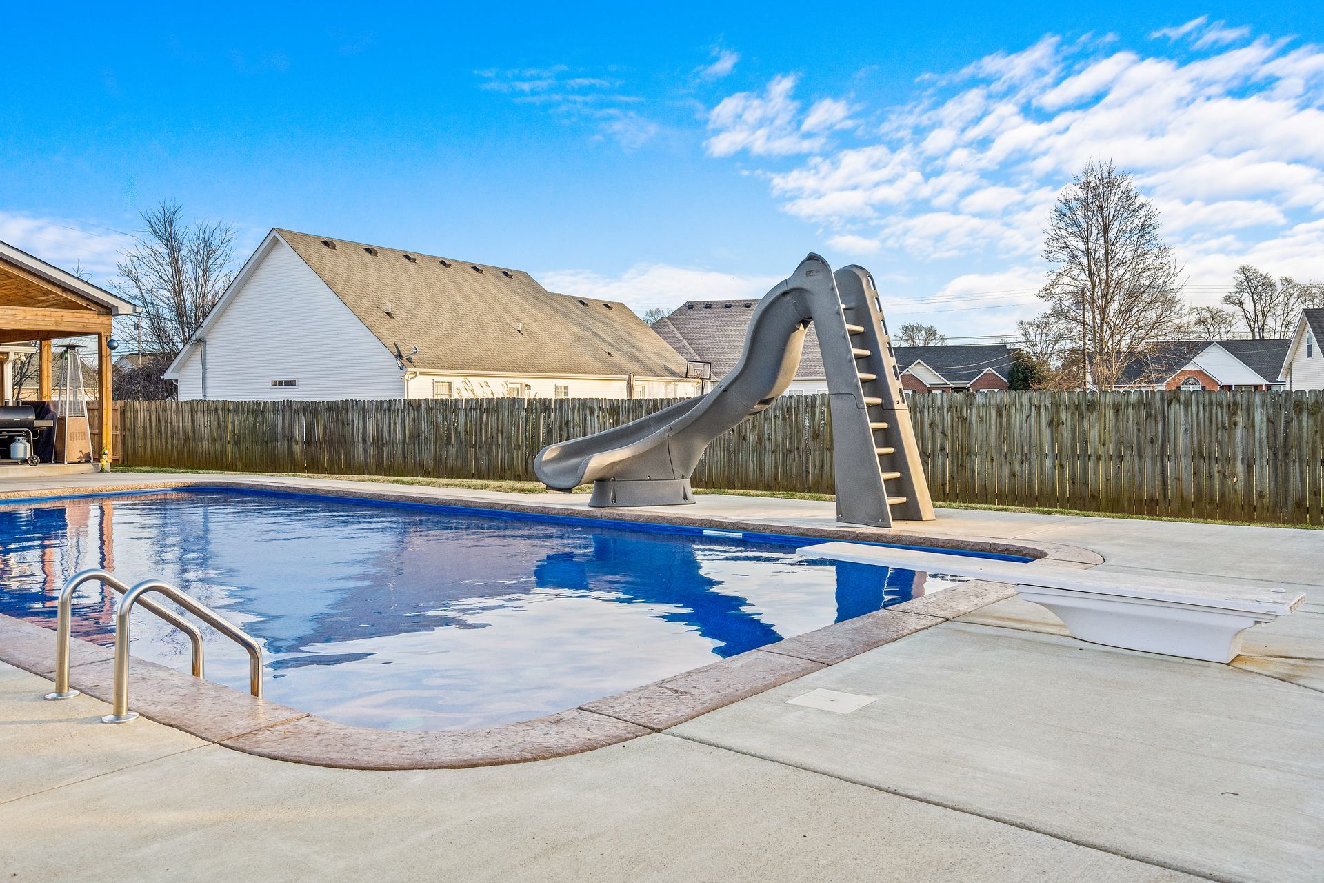 A swimming pool with a slide in the middle of it