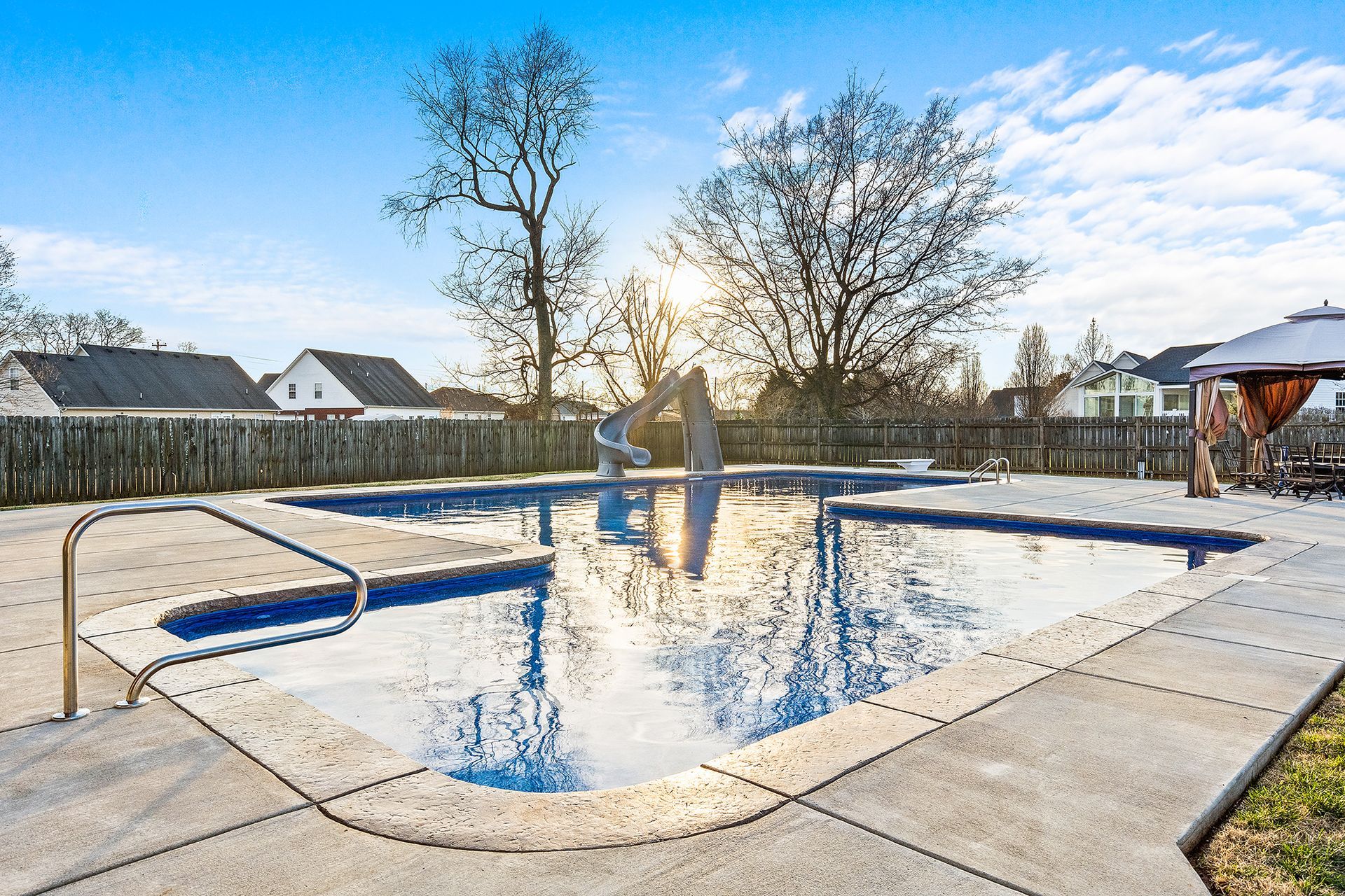 A large swimming pool with a slide in the middle of it