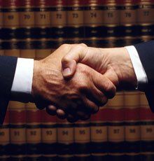 Client shaking hands with his attorney