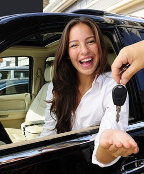 Happy woman receiving car key