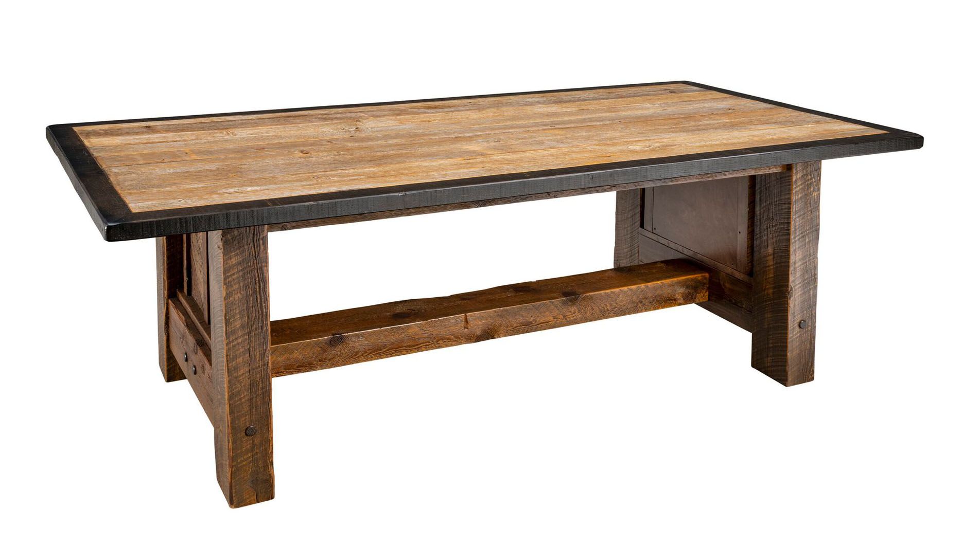 Rectangular rustic wooden dining table with a dark metal edge, sturdy trestle base, and weathered brown wood finish.