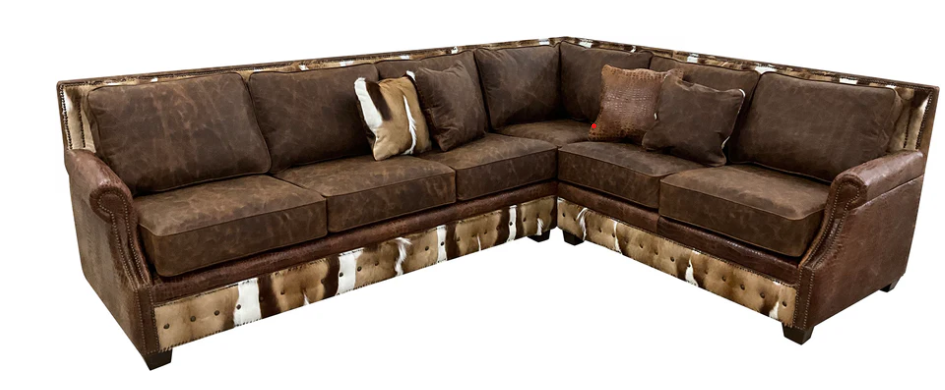 L-shaped sectional sofa in brown leather and fabric with cowhide trim along the bottom and rolled arms.