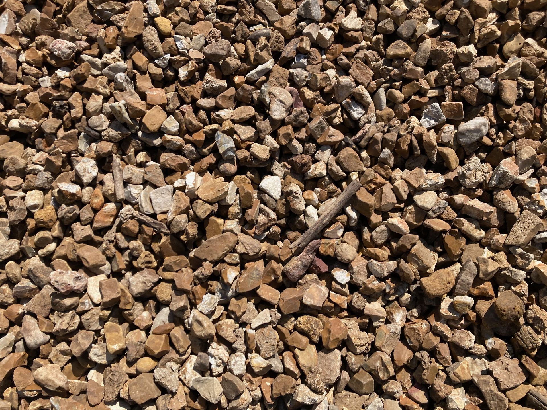 Pile of small tan and brown gravel stones covering the frame