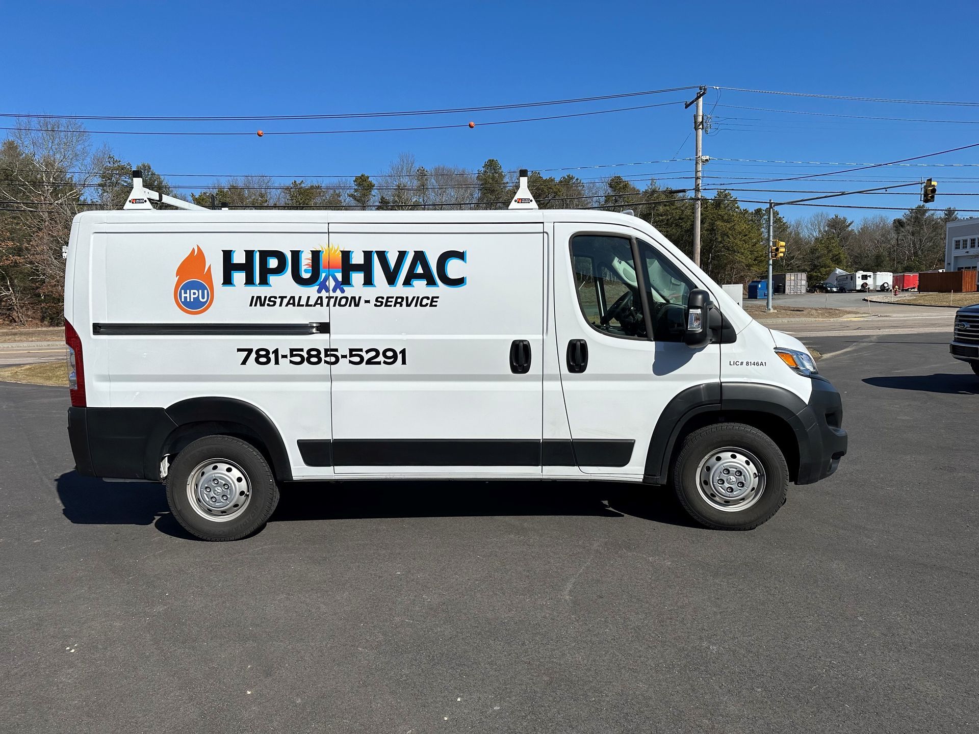 White HVAC van is parked on the side of the road .