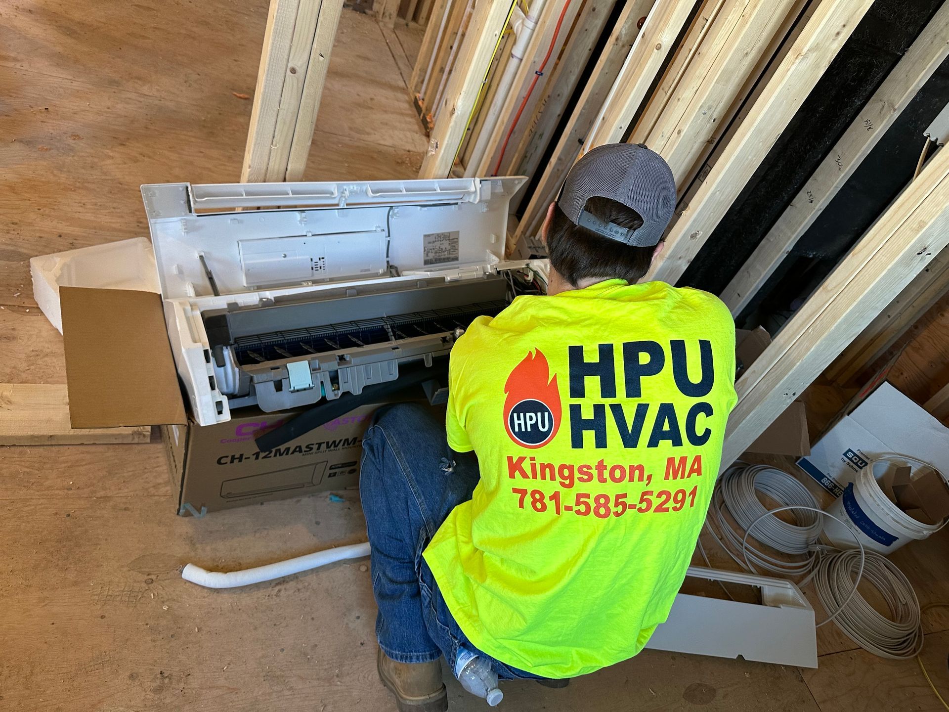 A man is working on an air conditioner