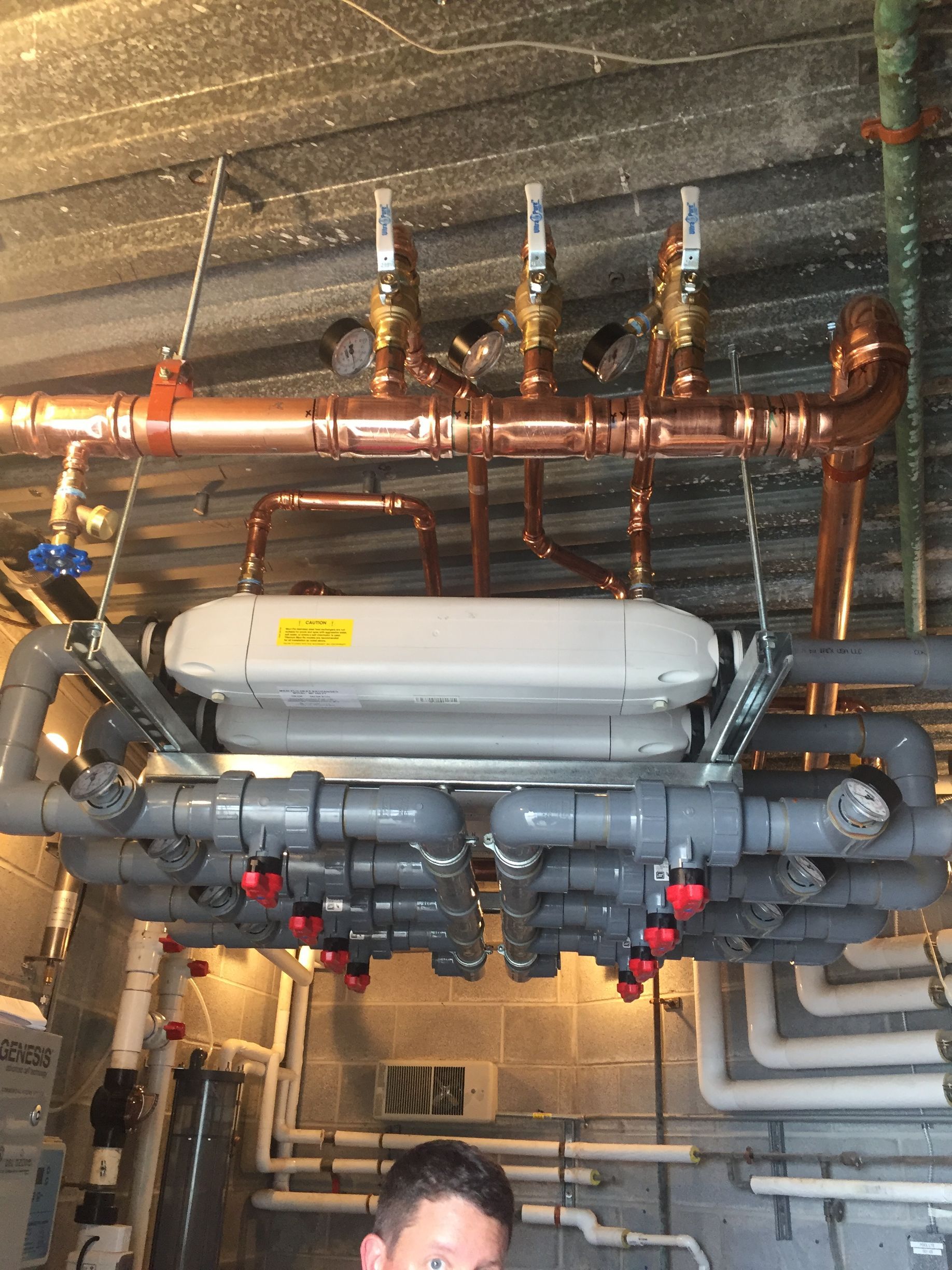 A room filled with lots of pipes and a ladder