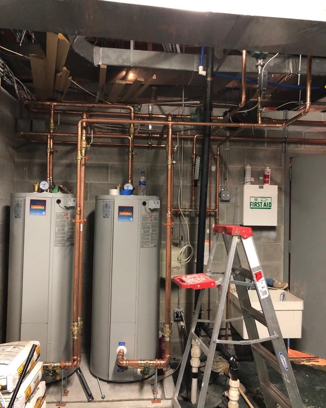 A bunch of pipes are connected to each other in a room.