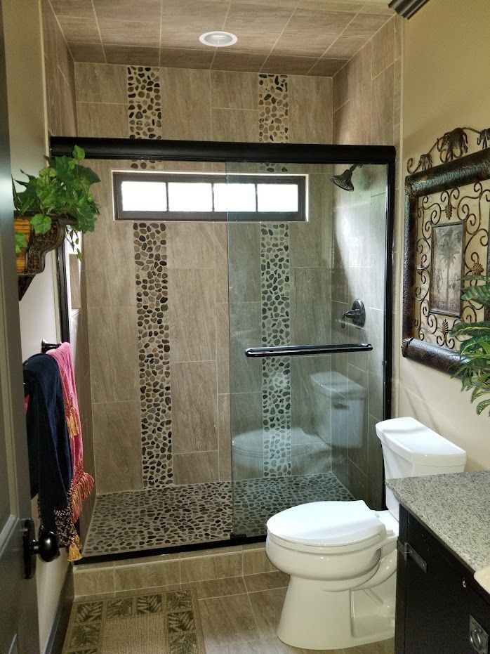 Bathroom with a toilet and a shower with a sliding glass door