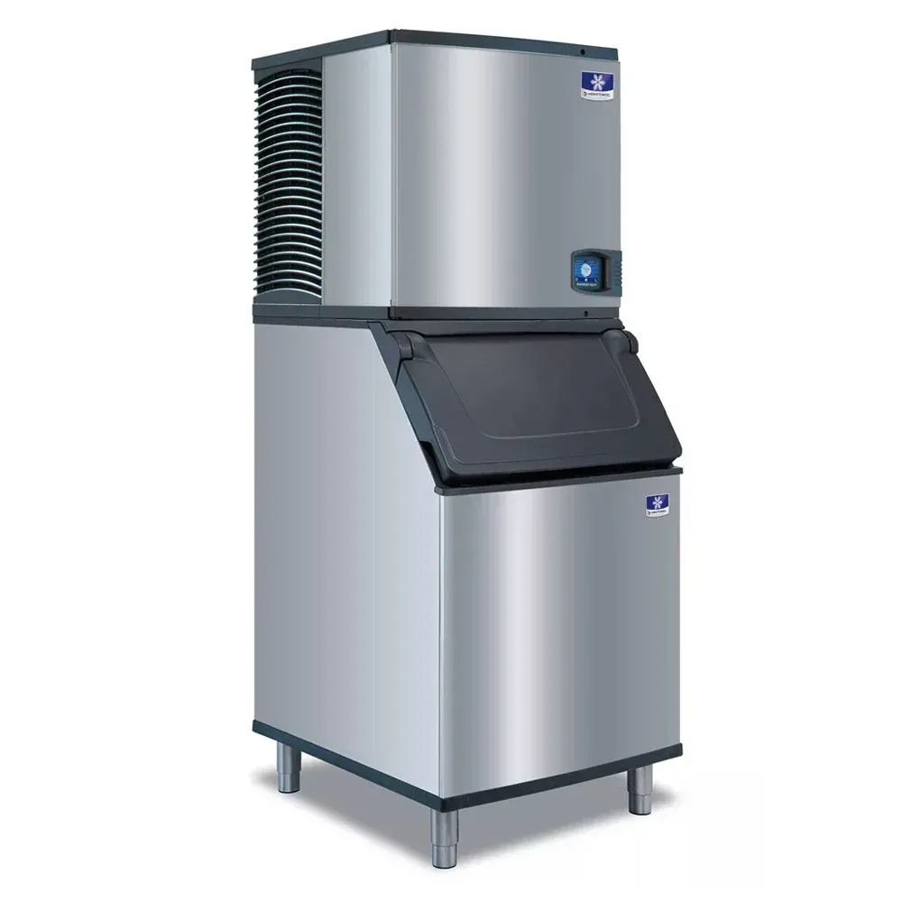 A stainless steel ice machine is sitting on a white surface.