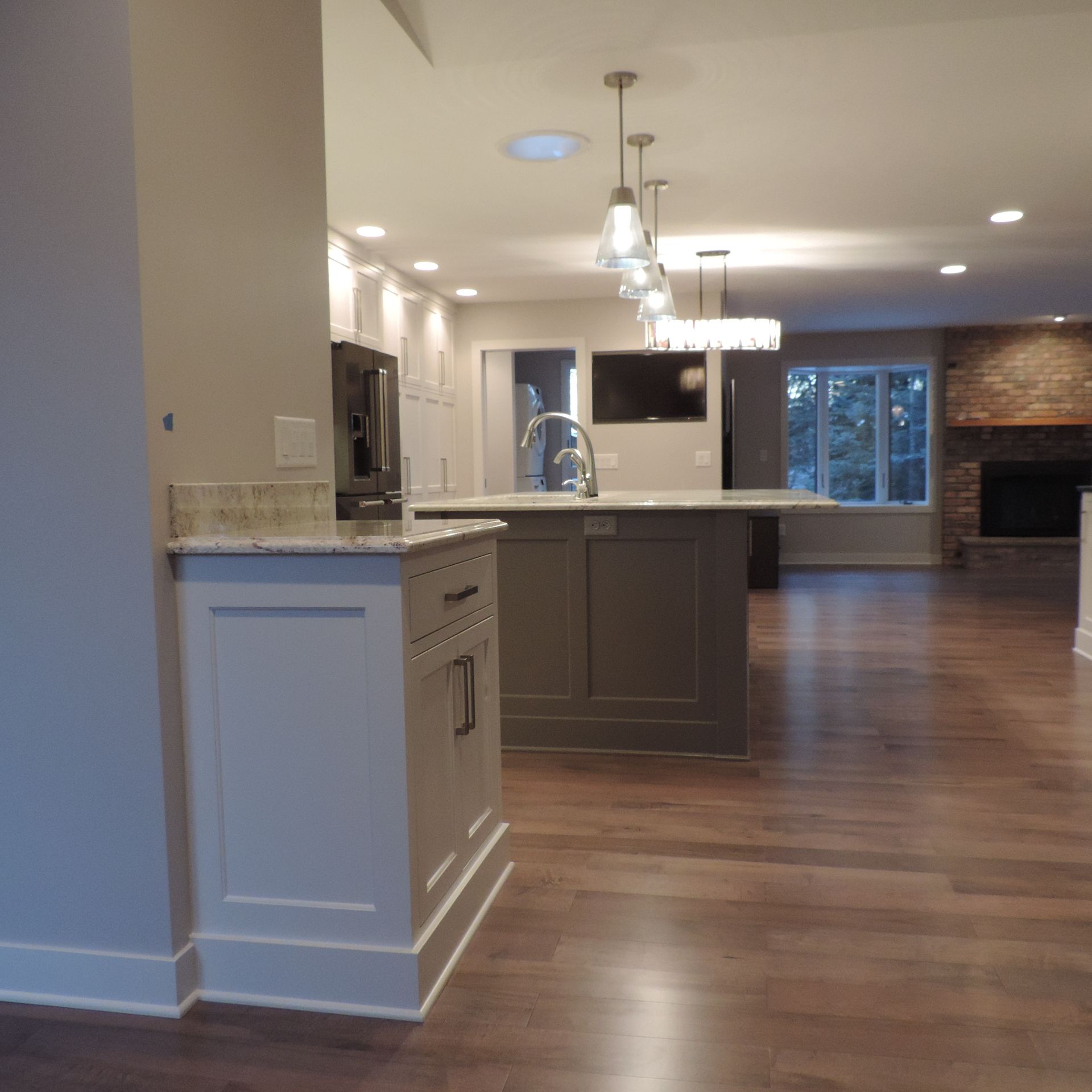 A kitchen with a large island and white cabinets