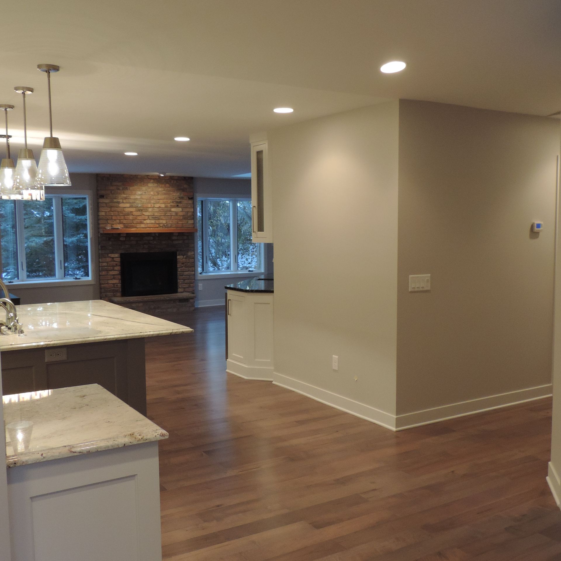 A kitchen with a large island and a fireplace