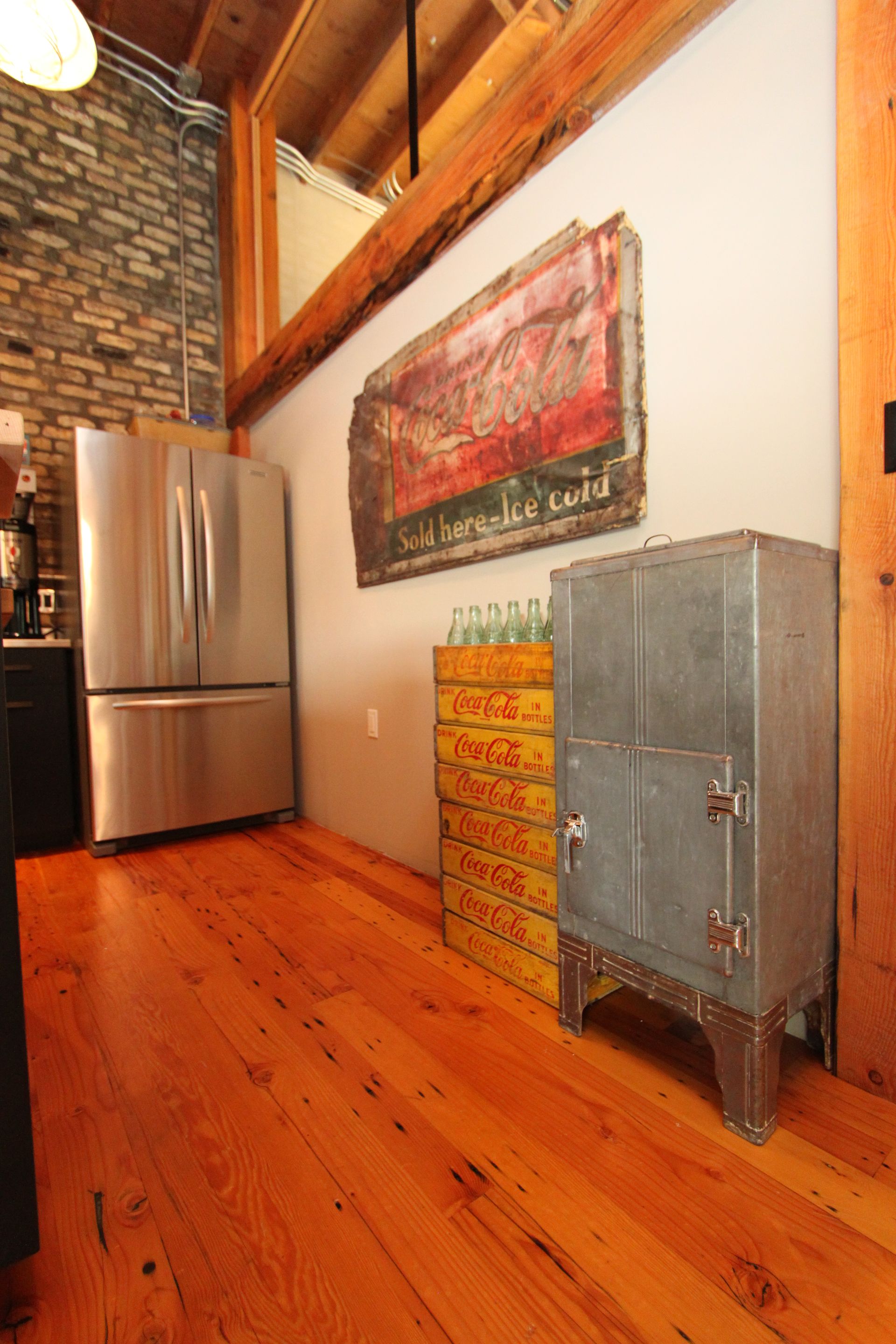 A kitchen with a stainless steel refrigerator and a metal cabinet