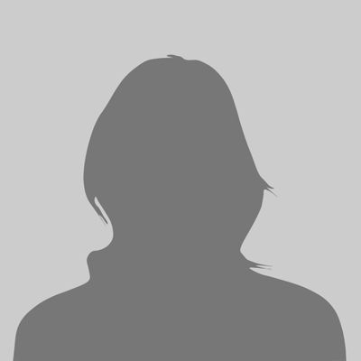 Silhouette of a person with short hair against a gray background.