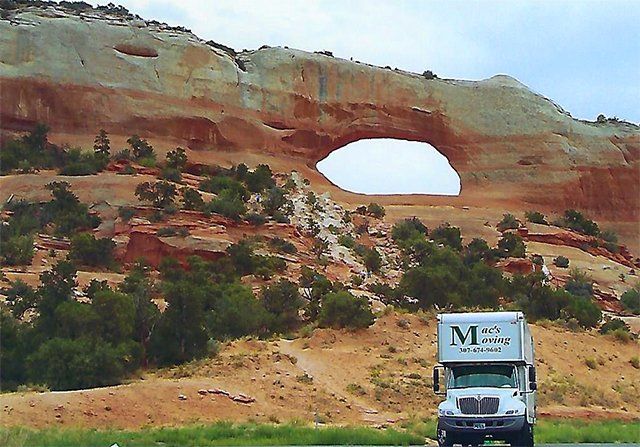 Mac's Moving truck passing through a beautiful geological rock formation