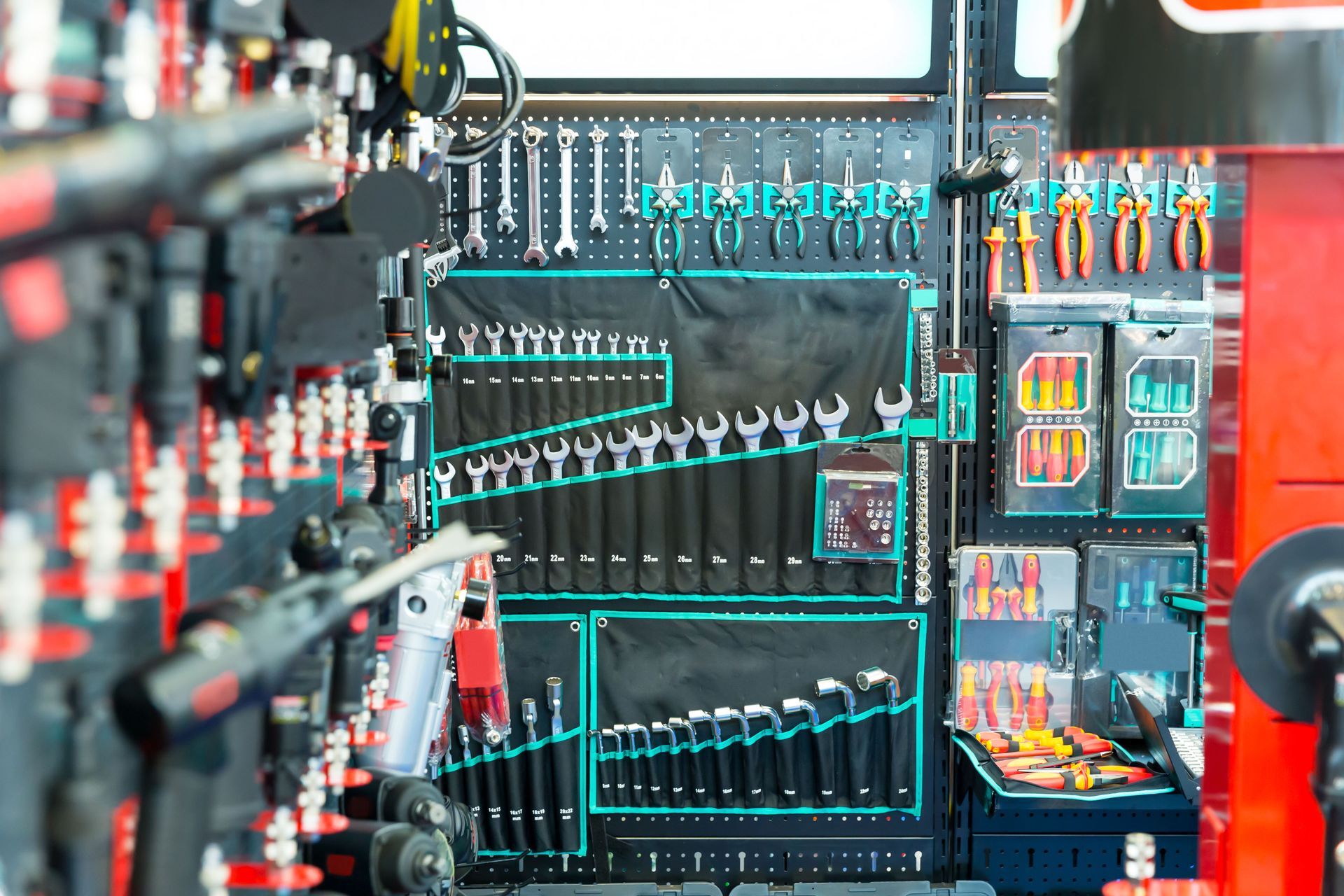 Industrial control panel with rows of switches, wiring, and illuminated indicators in a factory setting