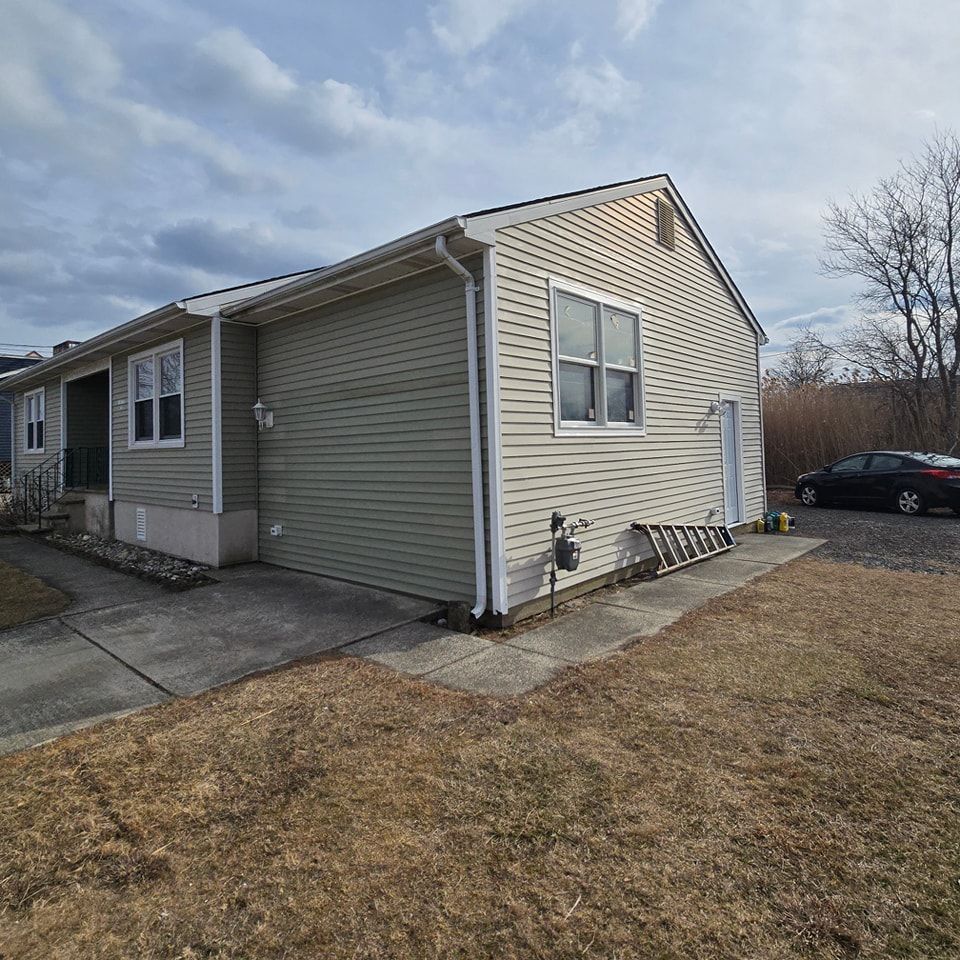 A small house with a car parked in front of it