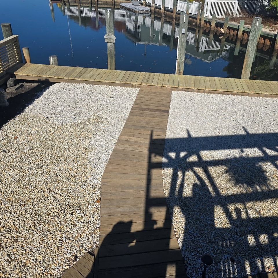 A wooden walkway leading to a body of water