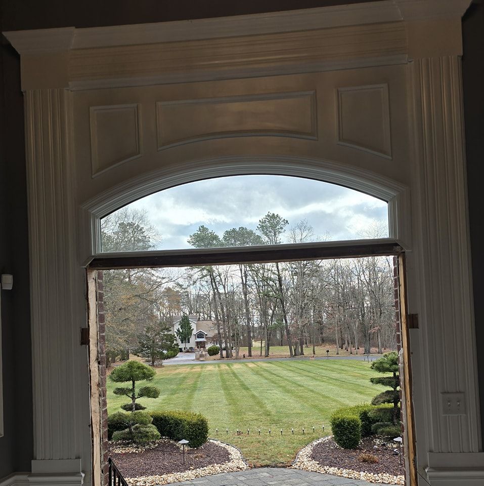 A view of a lush green field through a window