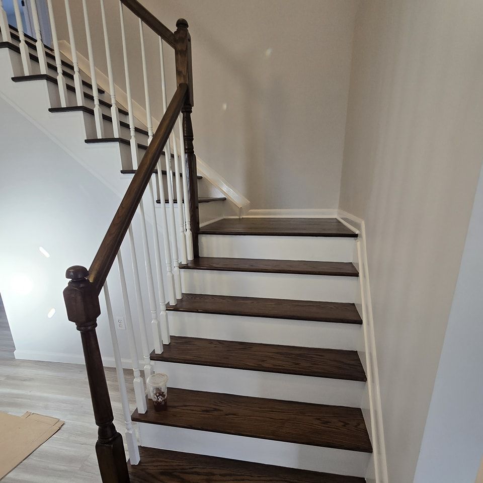 A staircase with wooden steps and a white railing in a house.