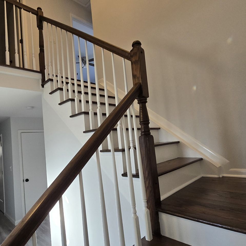 A staircase with a wooden railing and white steps