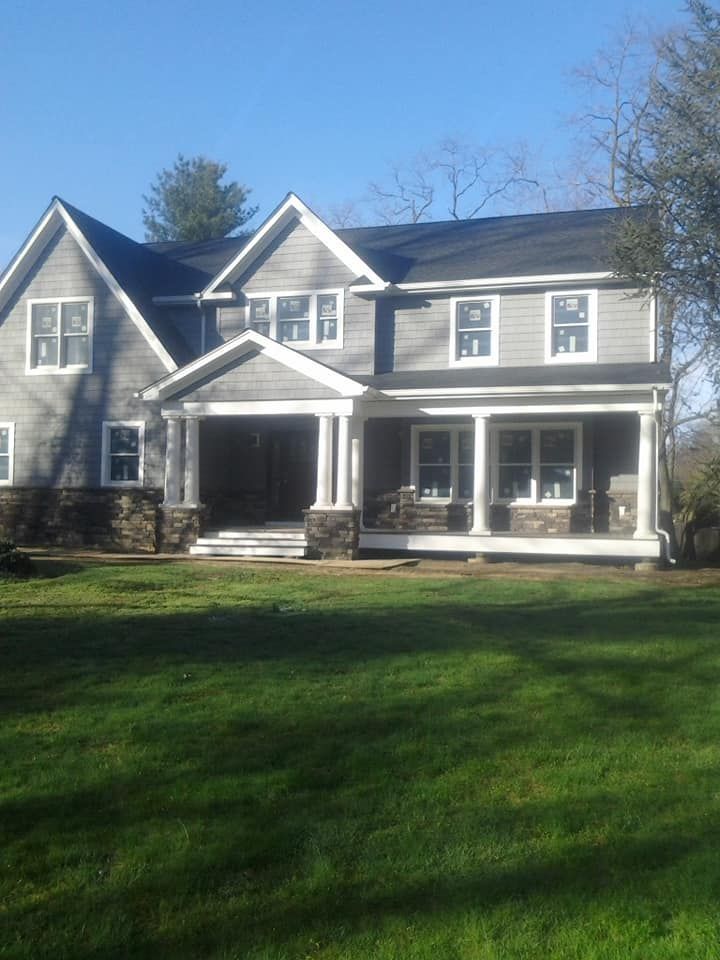 A large house with a large porch and lots of windows