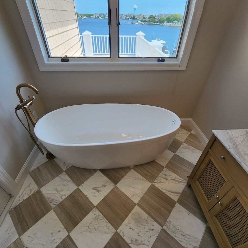 A bathtub in a bathroom with a checkered floor