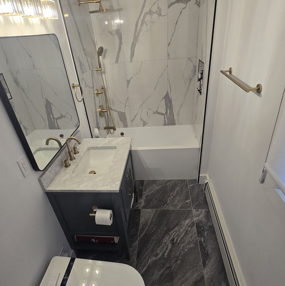 A bathroom with a toilet a sink and a mirror