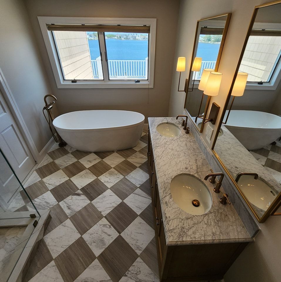 A bathroom with a bathtub and two sinks