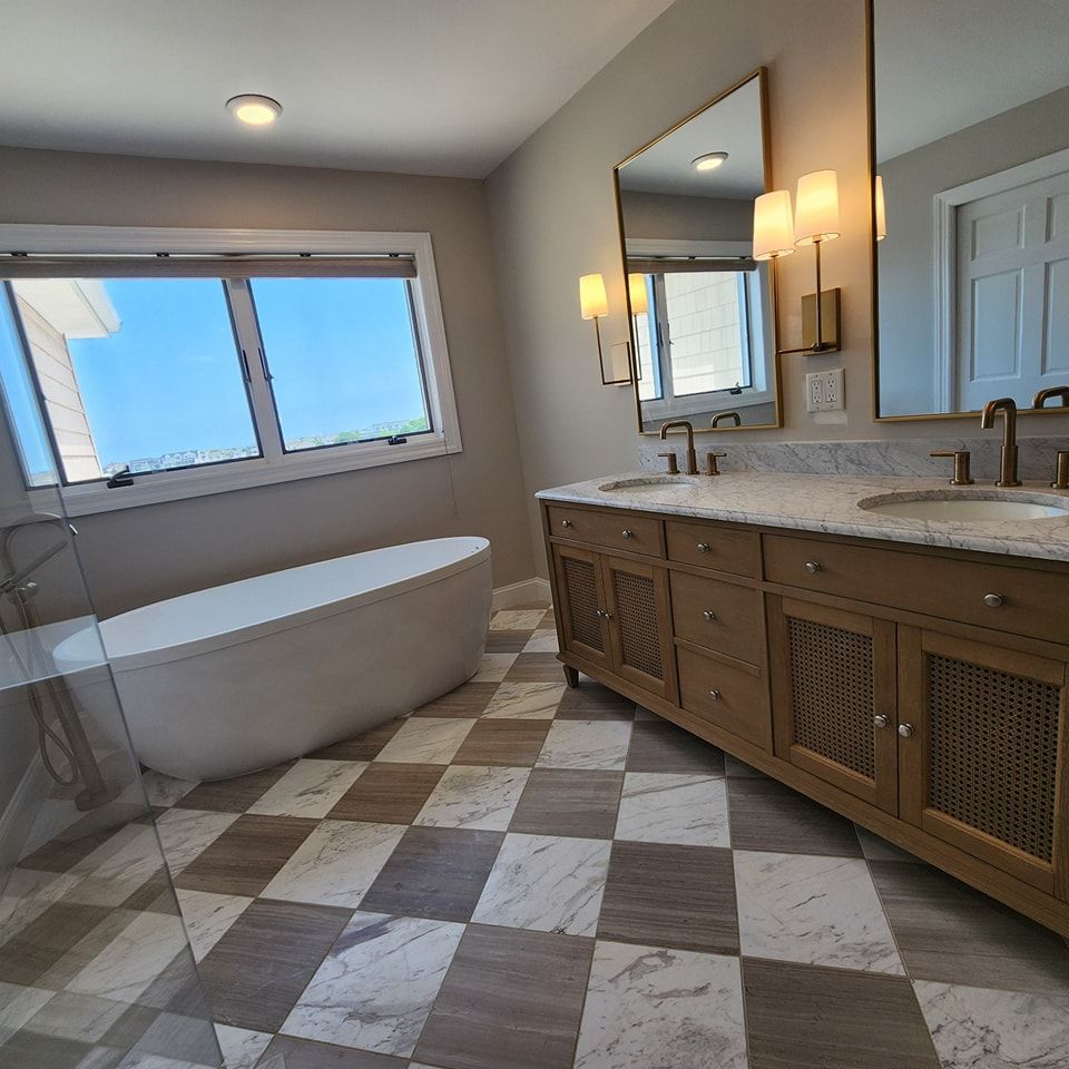 A bathroom with a bathtub and two sinks