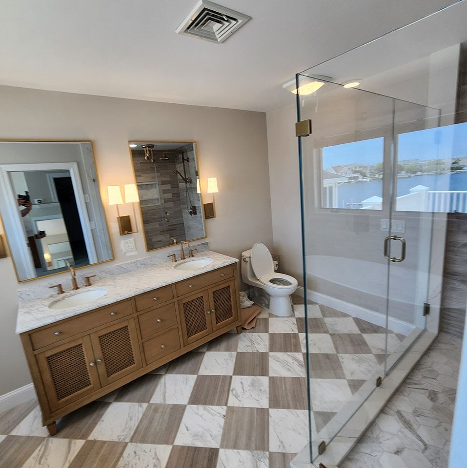 A bathroom with a toilet a sink and a mirror