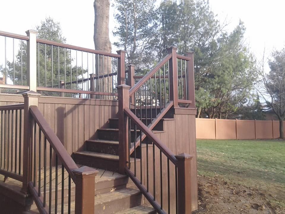 A wooden deck with stairs leading up to it
