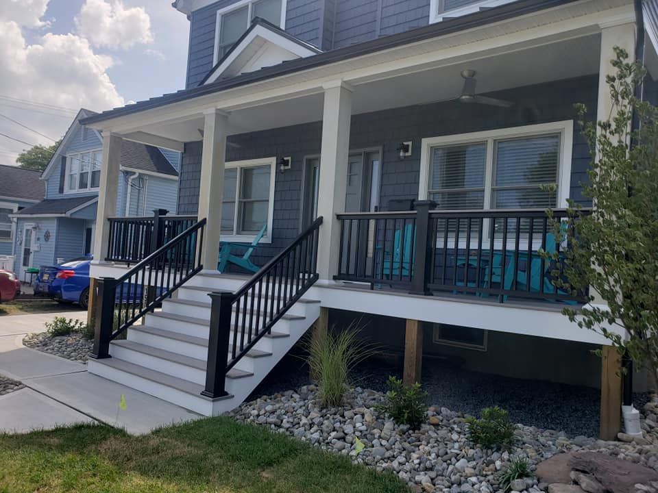 A house with a large porch and stairs leading up to it.