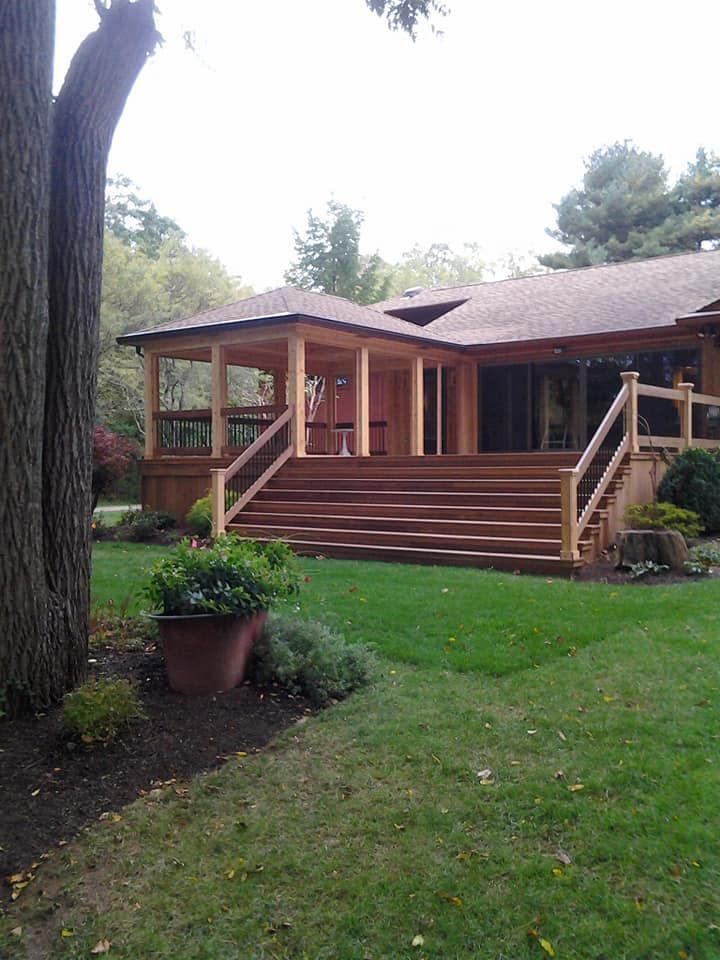 A house with a porch and stairs in the backyard