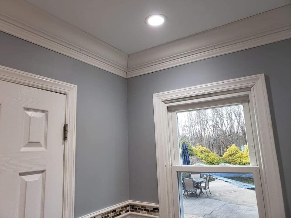 A bathroom with a window looking out to a patio.