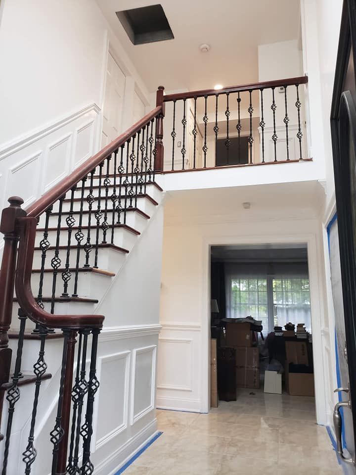 A hallway with stairs leading up to the second floor