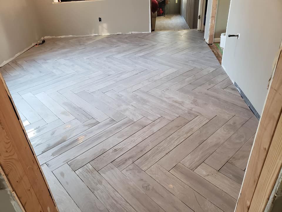A room with a herringbone pattern on the floor.
