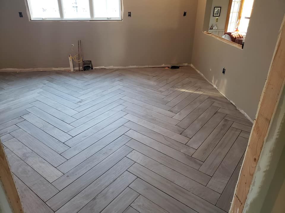 A room with a herringbone pattern on the floor