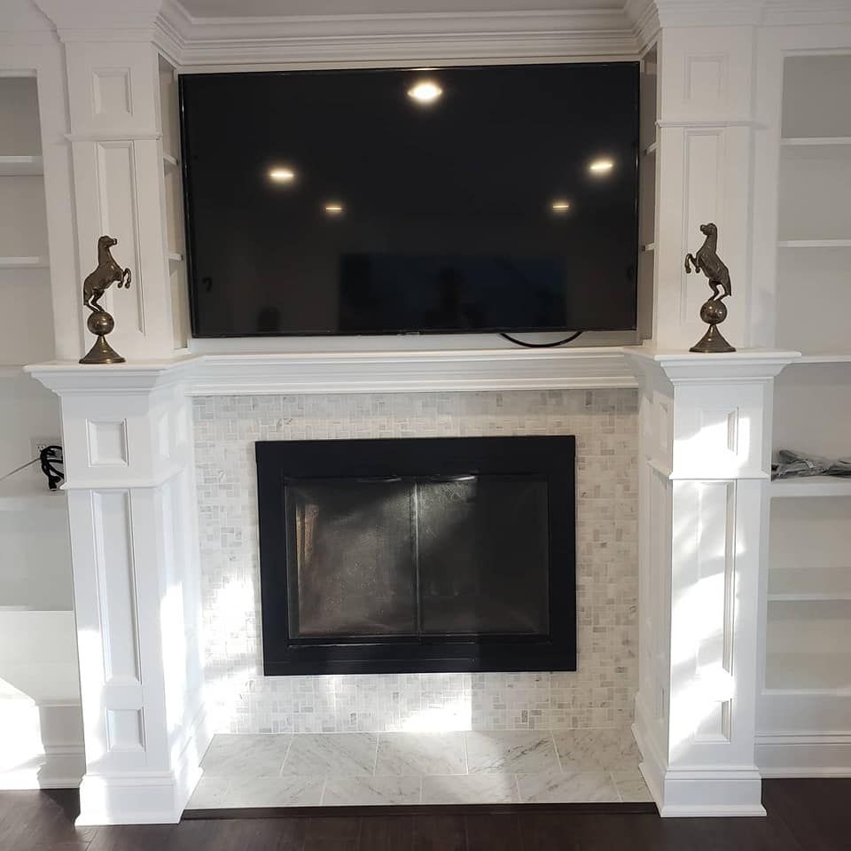 A fireplace with a flat screen tv above it