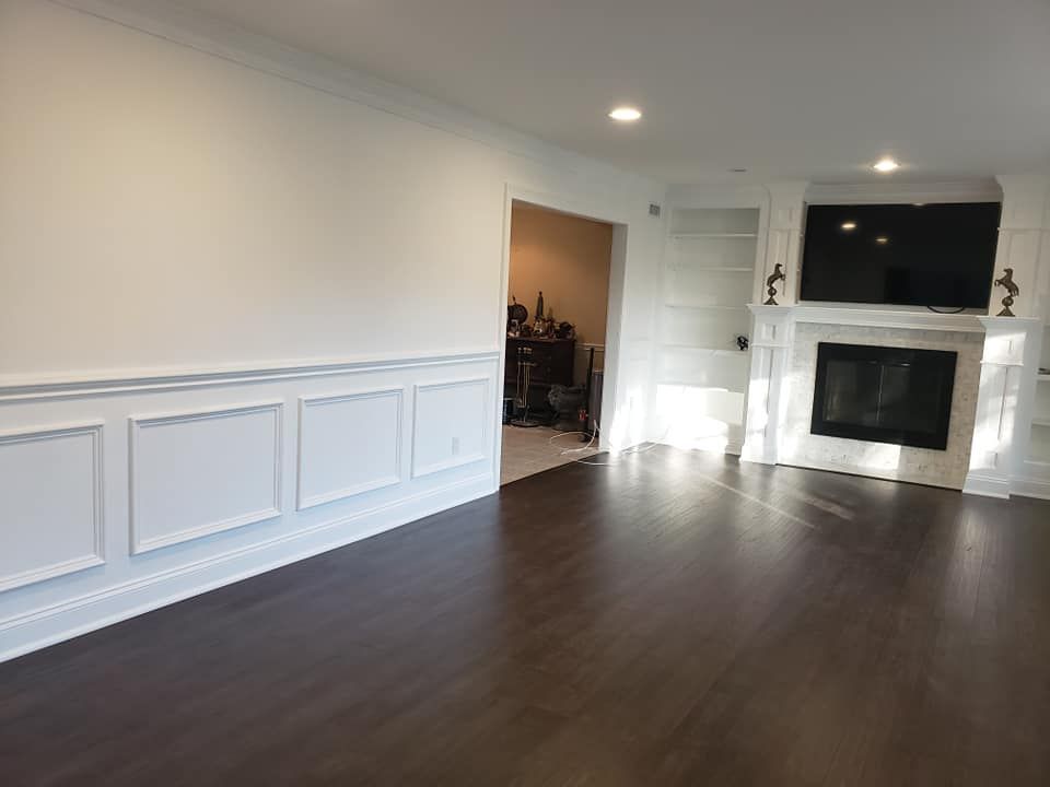 A living room with a fireplace and a flat screen tv.