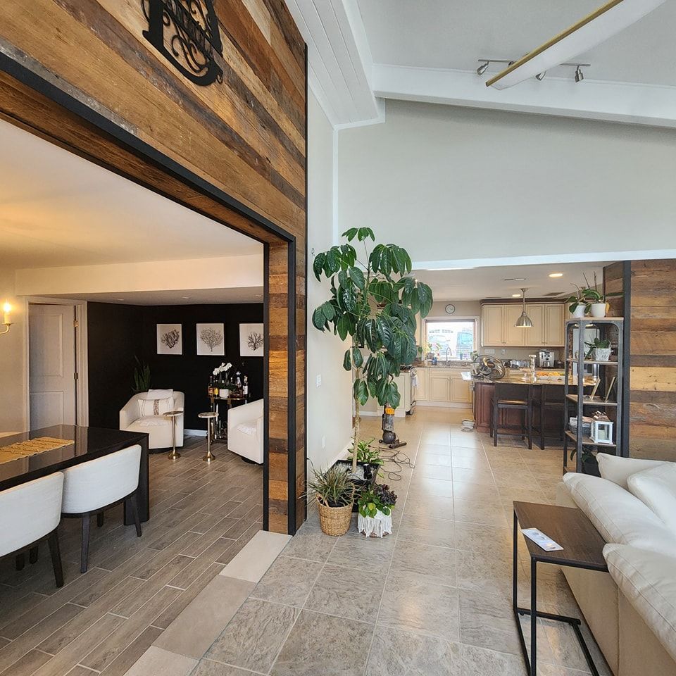 A living room with a couch a table and chairs