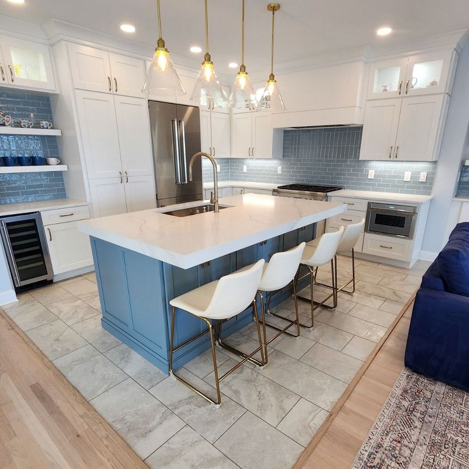There is a large island in the middle of the kitchen.