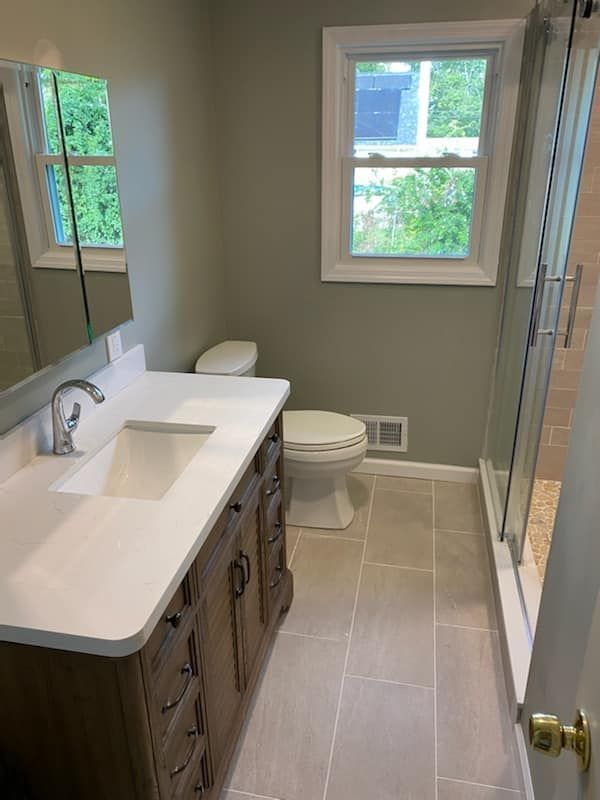 A bathroom with a sink , toilet , and shower.
