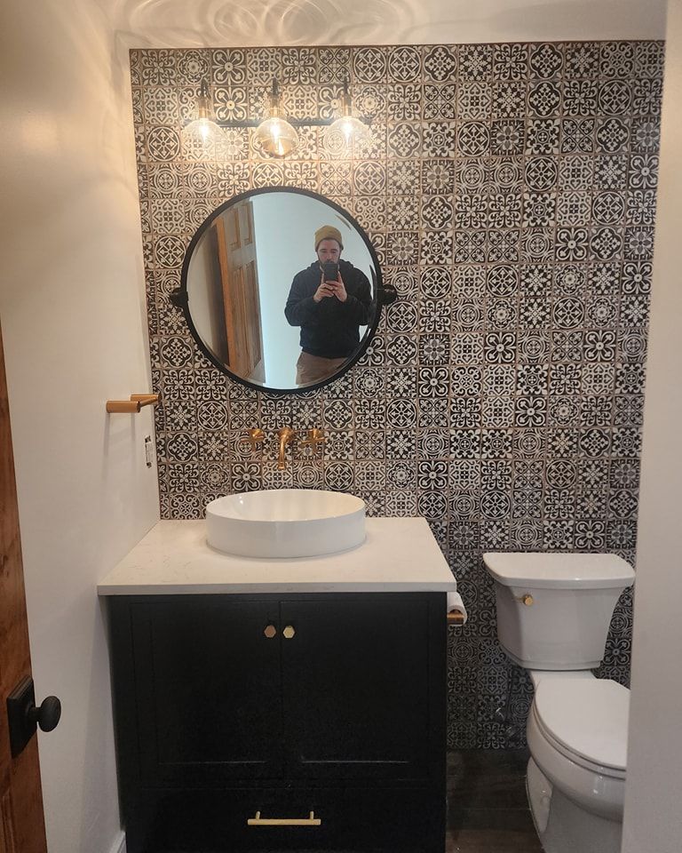 A bathroom with a sink , toilet and mirror.