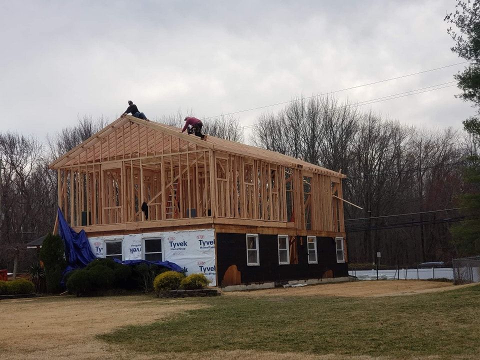 A house is being built in the middle of a field.