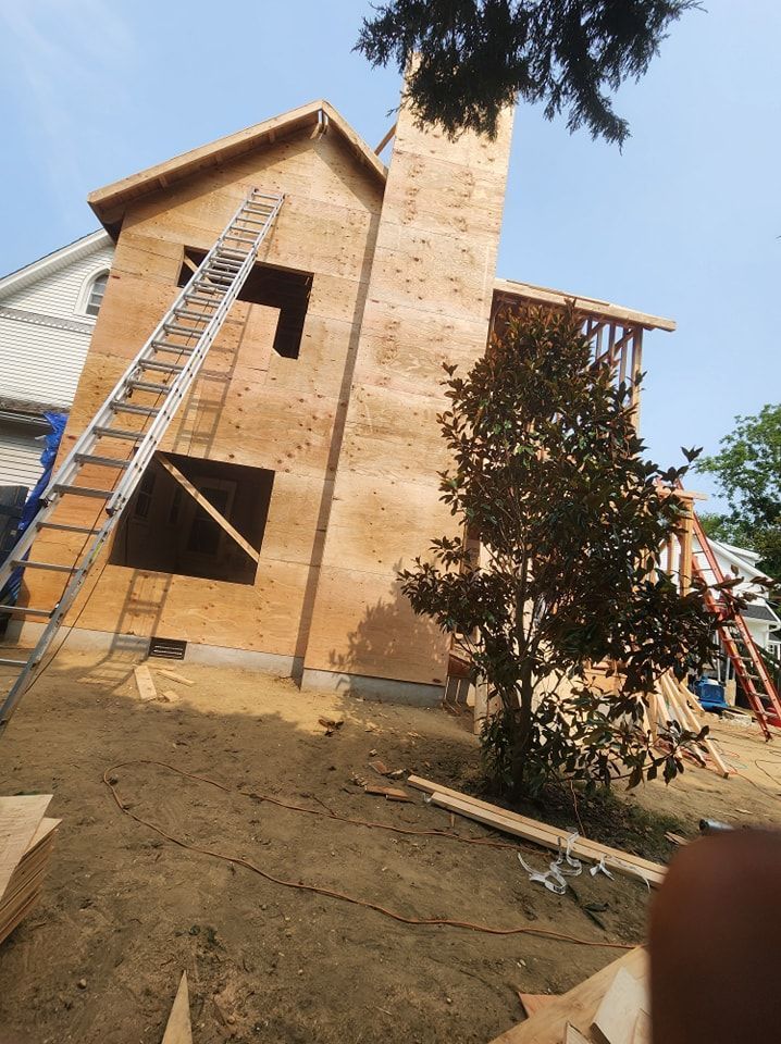 A house under construction with a ladder on the side of it