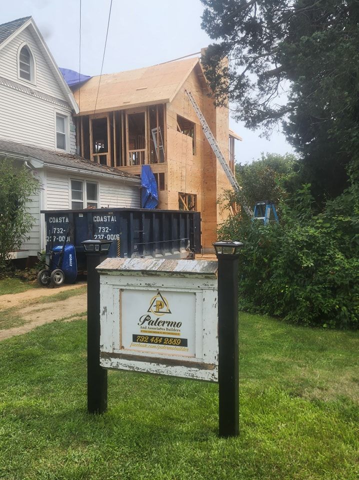 A sign in front of a house that is being built