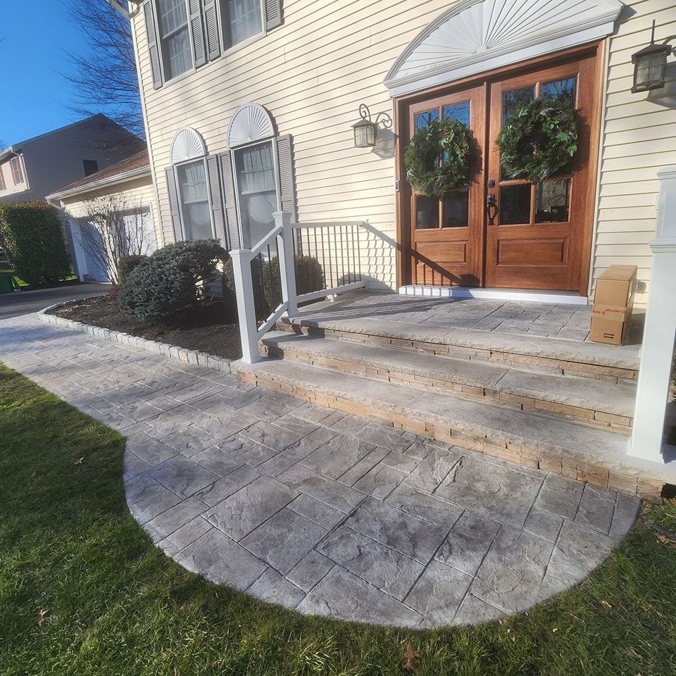 A house with a concrete walkway leading to the front door