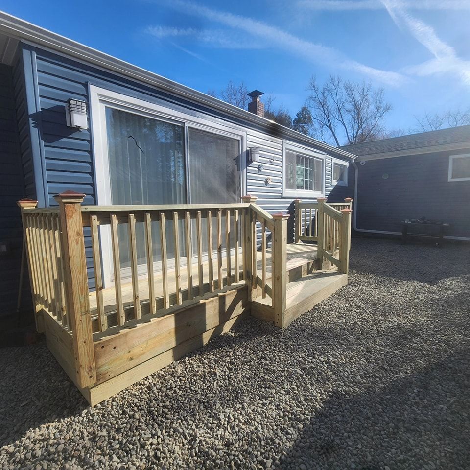 A house with a wooden deck in front of it