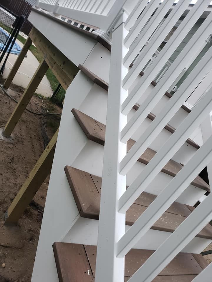 A staircase with a white railing and wooden steps